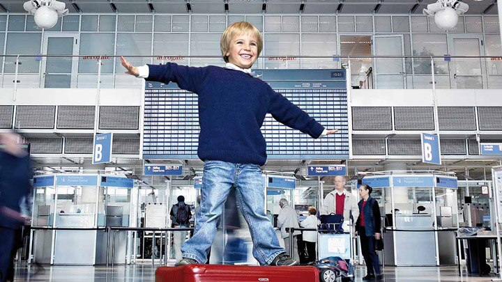 Happy child in an airport terminal